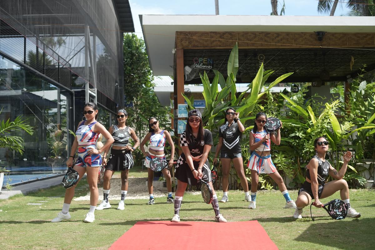 Players wearing Bad Padel's Padel Bad Girl and Ooh La La collections on a red carpet next to the courts